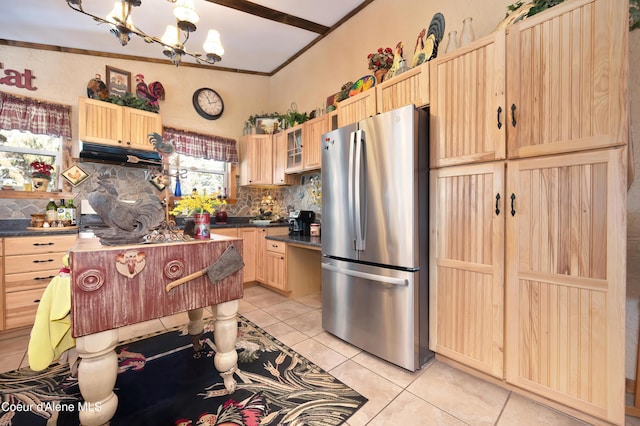 kitchen featuring light tile patterned flooring, stainless steel fridge, light brown cabinetry, and decorative backsplash