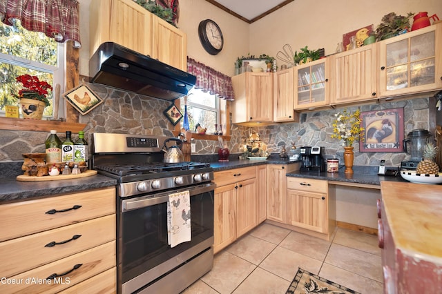 kitchen featuring light brown cabinetry, gas range, and ventilation hood