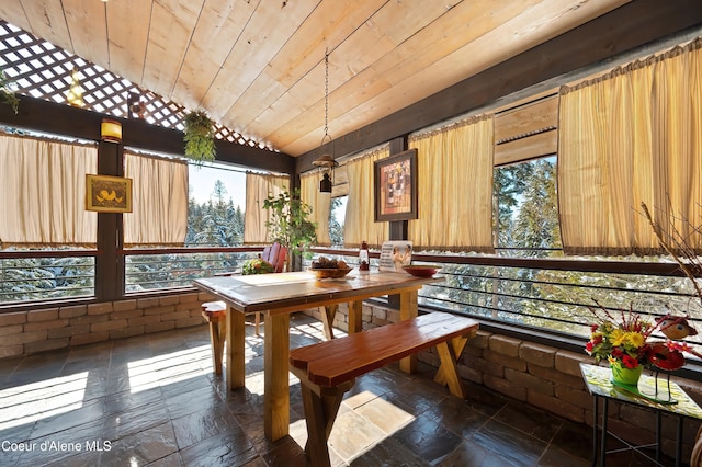 dining space featuring vaulted ceiling and wooden ceiling