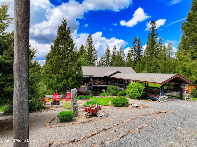 110 Shamrock Ln, Saint Maries, ID 83861 - view of front of property with a wooden deck, stairs, an outdoor fire pit, and a shingled roof