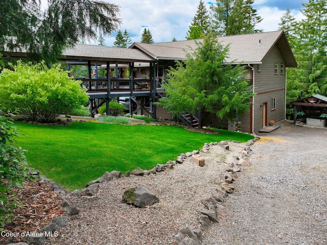 110 Shamrock Ln, Saint Maries, ID 83861 - back of house with stairs, roof with shingles, a lawn, and a wooden deck