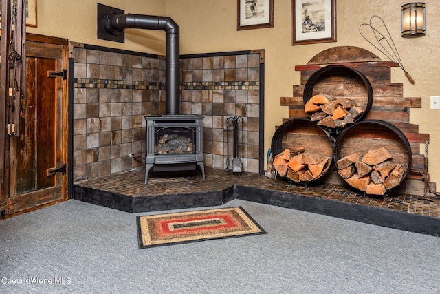 110 Shamrock Ln, Saint Maries, ID 83861 - detailed view of a wood stove, carpet floors, and a textured wall