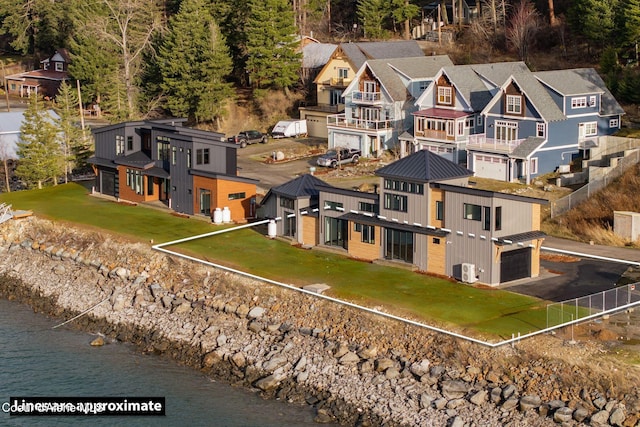 drone / aerial view featuring a residential view and a water view