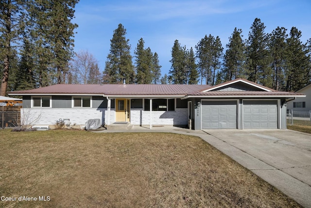 single story home featuring metal roof, an attached garage, brick siding, driveway, and a front lawn