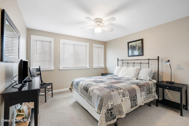 bedroom featuring light carpet, ceiling fan, and baseboards