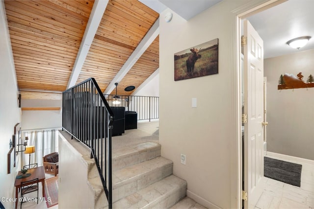 stairway with lofted ceiling with beams, wood ceiling, and baseboards