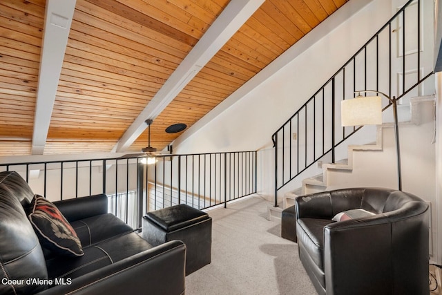 carpeted living area featuring lofted ceiling with beams, wood ceiling, stairway, and a ceiling fan