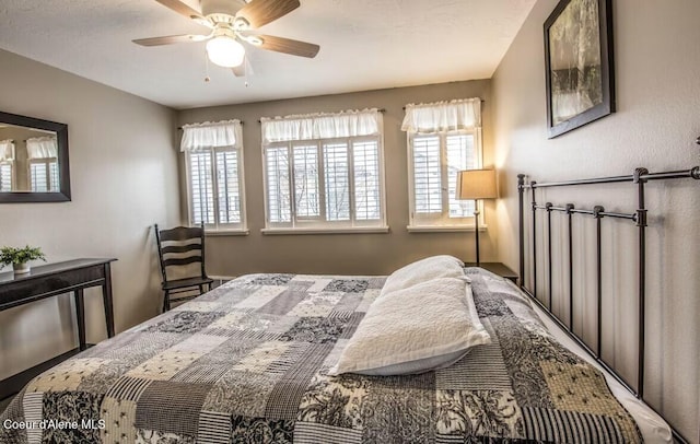 bedroom featuring multiple windows and ceiling fan