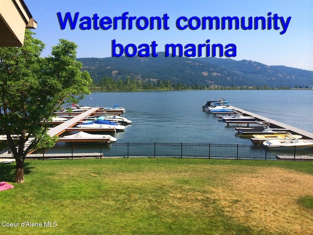 view of water feature with a dock and a mountain view