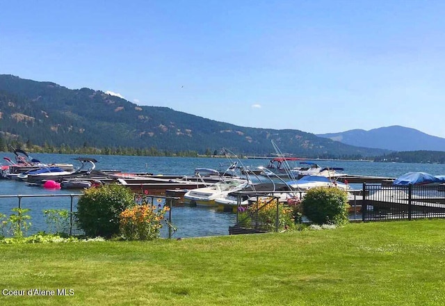 water view featuring a mountain view and a boat dock