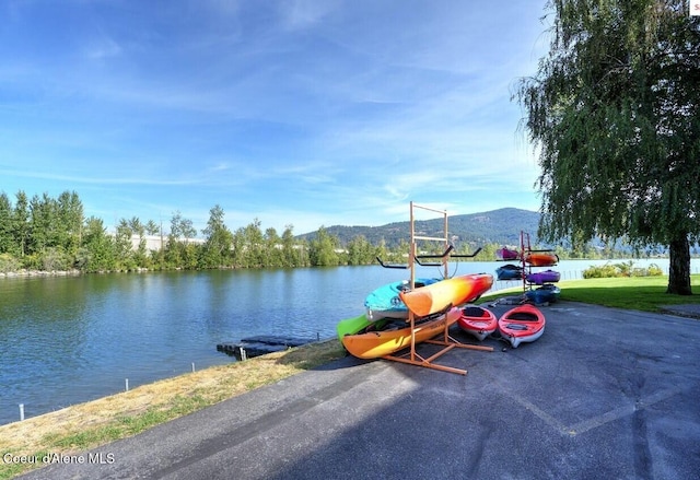 exterior space with a water and mountain view