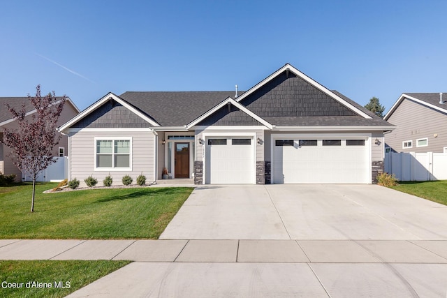 craftsman-style house featuring a front lawn and a garage