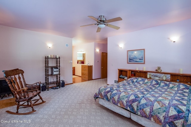 bedroom with light colored carpet and ensuite bath