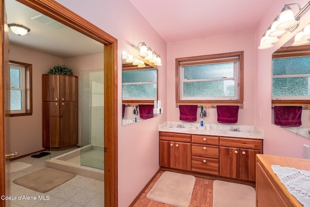 bathroom with vanity and a shower with shower door