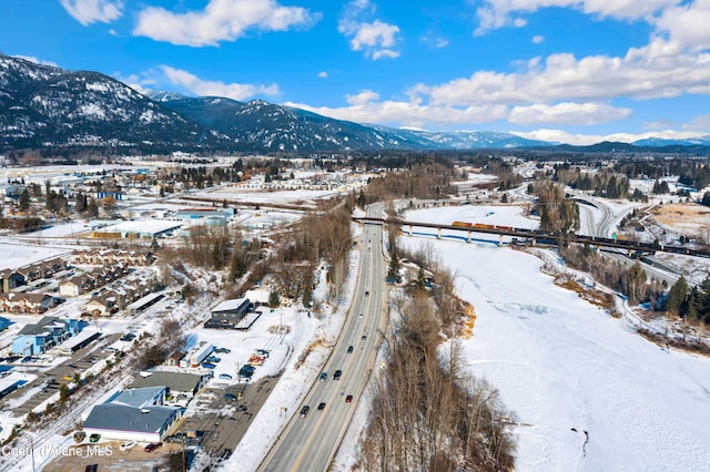 snowy aerial view with a mountain view