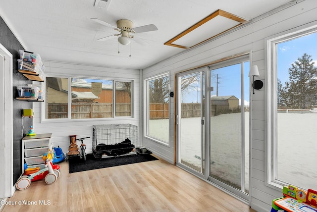 sunroom / solarium featuring ceiling fan