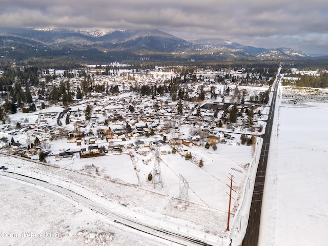 snowy aerial view with a mountain view