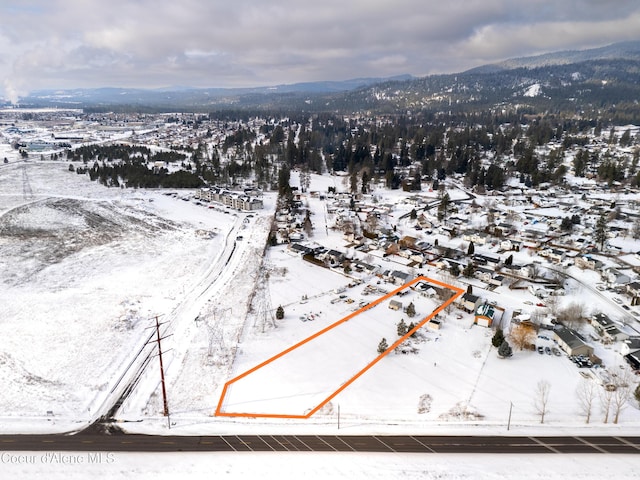 snowy aerial view featuring a mountain view