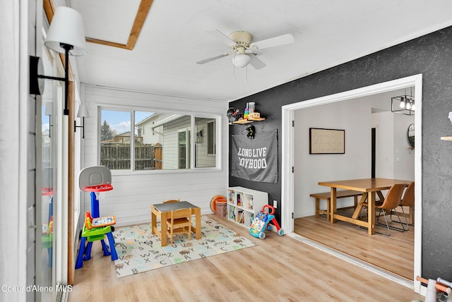 playroom with ceiling fan and wood-type flooring