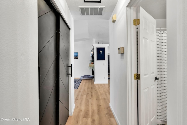 hallway with light wood-type flooring