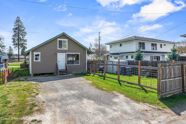 1108 Pine St, Sandpoint, ID 83864 - view of front of home featuring a front yard, driveway, entry steps, and fence