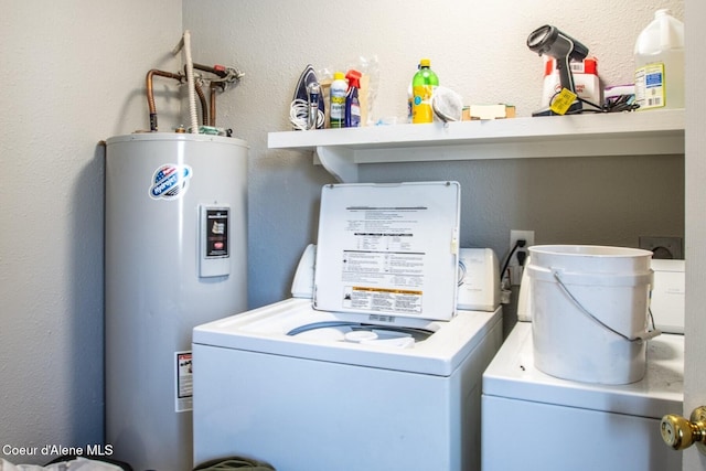 clothes washing area featuring washing machine and dryer and water heater
