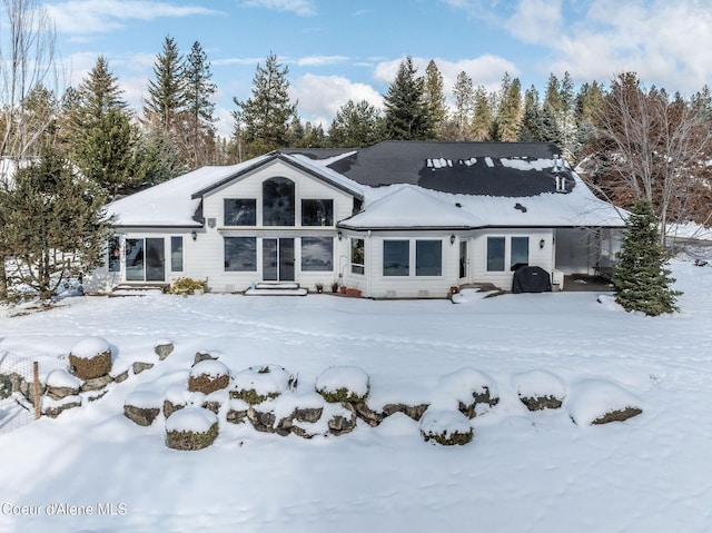 view of snow covered back of property