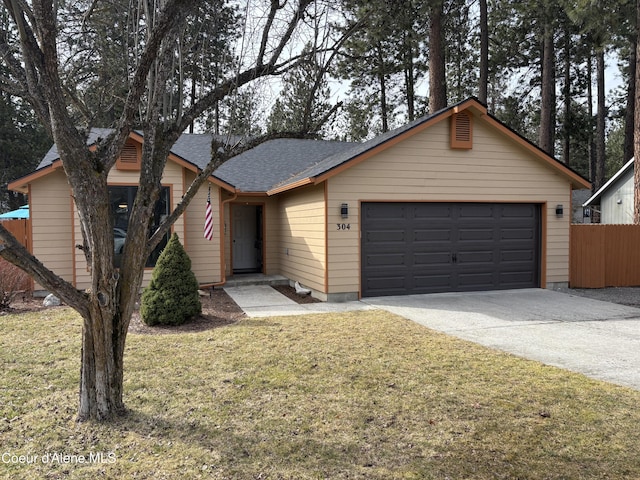 ranch-style house featuring a garage, fence, a front lawn, and concrete driveway