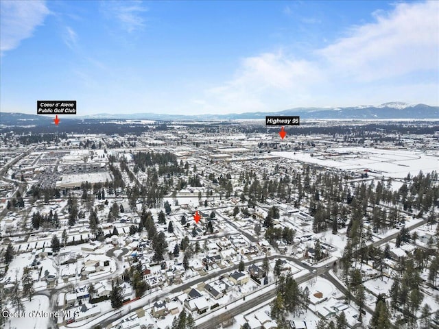 snowy aerial view featuring a mountain view