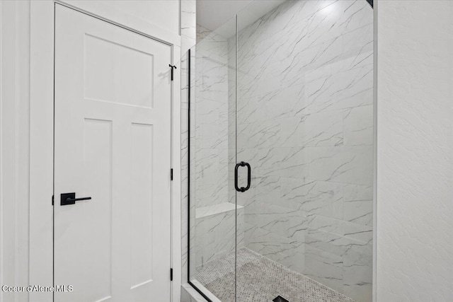 bathroom featuring a shower with door