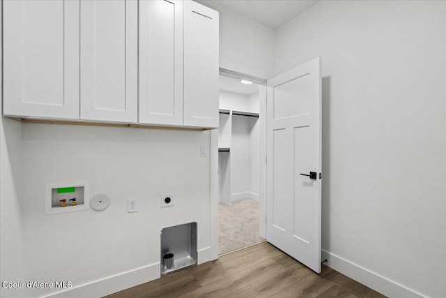 laundry room with cabinets, hookup for an electric dryer, gas dryer hookup, light hardwood / wood-style flooring, and washer hookup