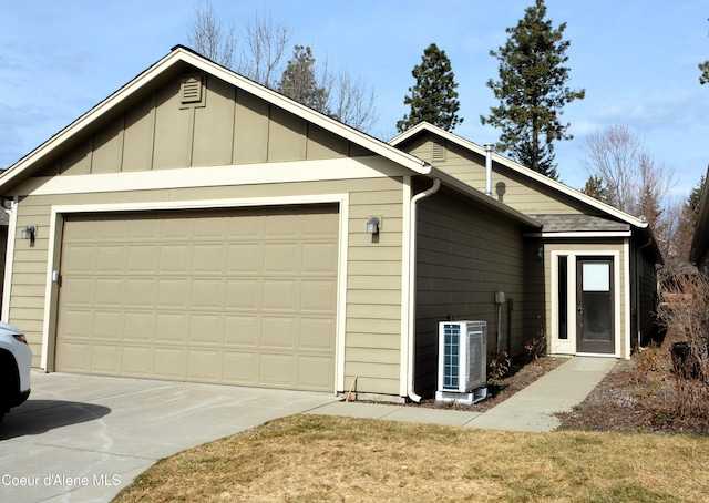 view of front of property featuring board and batten siding, central AC unit, concrete driveway, and an attached garage