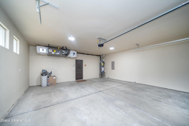 garage with electric panel, secured water heater, and a garage door opener