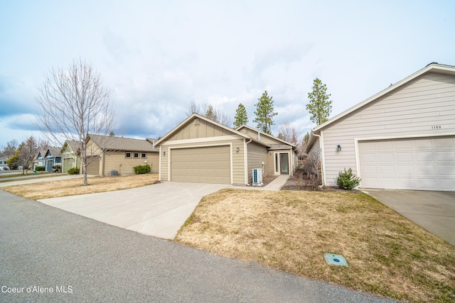 ranch-style home with a front lawn, board and batten siding, and driveway