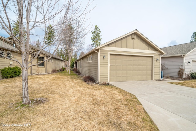 view of front of property with a front lawn, a garage, and board and batten siding