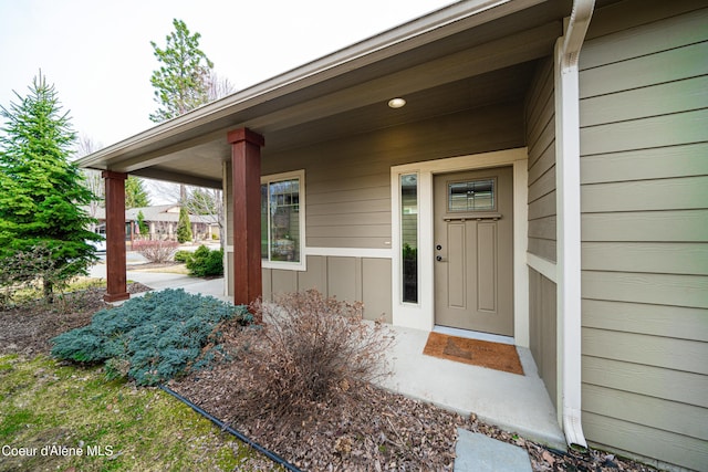 property entrance with board and batten siding and a porch