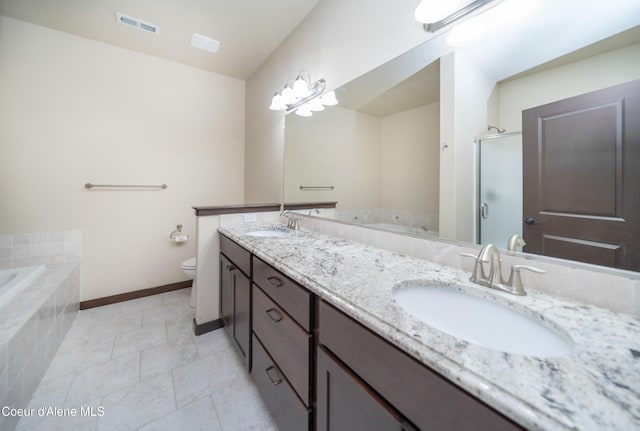 full bathroom with double vanity, toilet, visible vents, and a sink