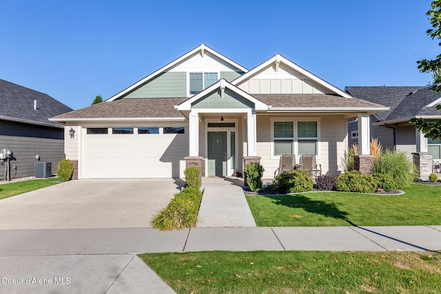 craftsman inspired home featuring a porch, concrete driveway, board and batten siding, central AC, and a garage