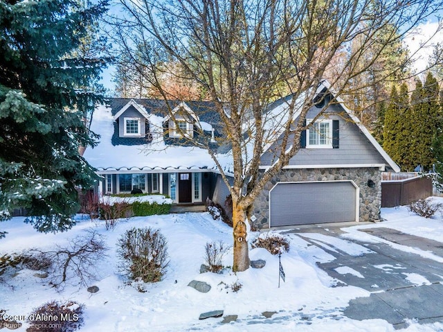 view of front of property featuring stone siding and an attached garage