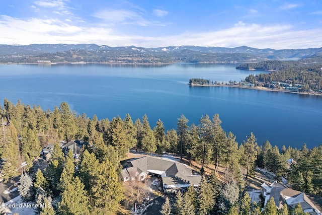 birds eye view of property featuring a water and mountain view