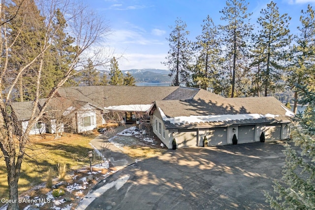 view of front of property with roof with shingles and a mountain view