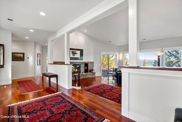 5006 S Brentwood Ln, Coeur Dalene, ID 83814 - dining area with lofted ceiling, recessed lighting, visible vents, a stone fireplace, and wood finished floors