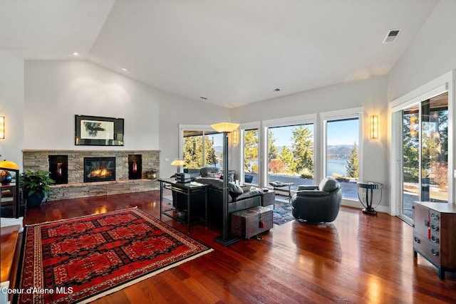 5006 S Brentwood Ln, Coeur Dalene, ID 83814 - living room with dark wood-style flooring, recessed lighting, visible vents, vaulted ceiling, and a stone fireplace