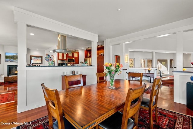 5006 S Brentwood Ln, Coeur Dalene, ID 83814 - dining area featuring a glass covered fireplace, recessed lighting, and wood finished floors