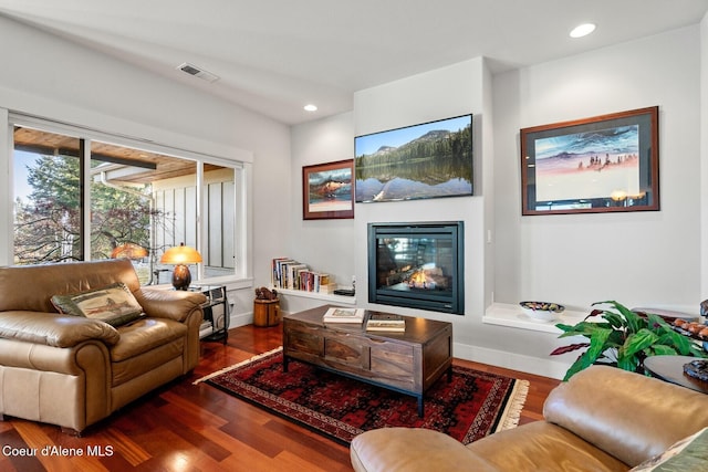 5006 S Brentwood Ln, Coeur Dalene, ID 83814 - living area with visible vents, dark wood finished floors, baseboards, a glass covered fireplace, and recessed lighting