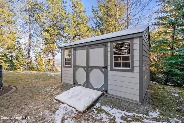 5006 S Brentwood Ln, Coeur Dalene, ID 83814 - snow covered structure featuring a storage unit and an outdoor structure