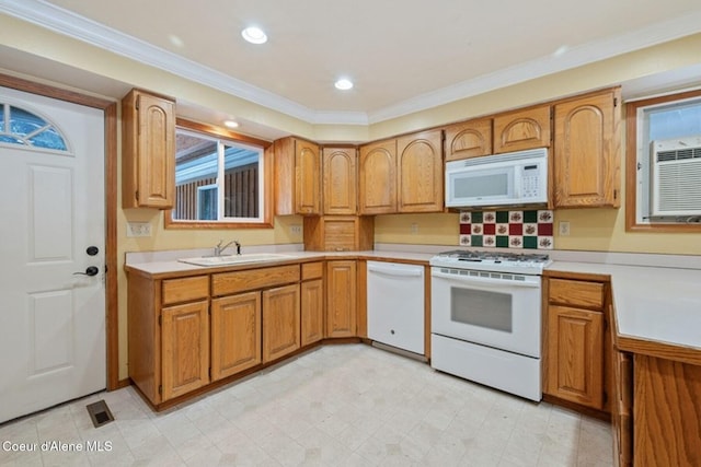 kitchen featuring ornamental molding, white appliances, light countertops, and a sink