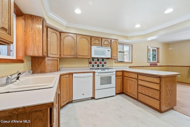 kitchen featuring white appliances, light countertops, a peninsula, and light floors