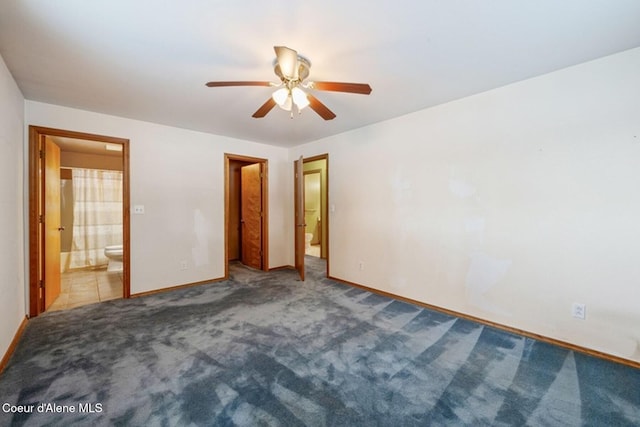 unfurnished bedroom with baseboards, light colored carpet, and ensuite bath