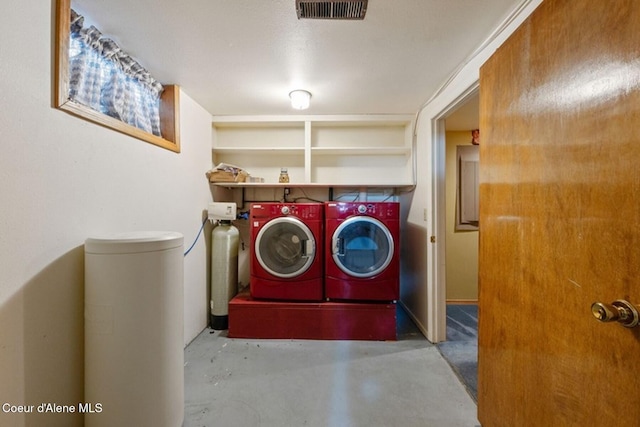 washroom with laundry area, visible vents, and washing machine and clothes dryer